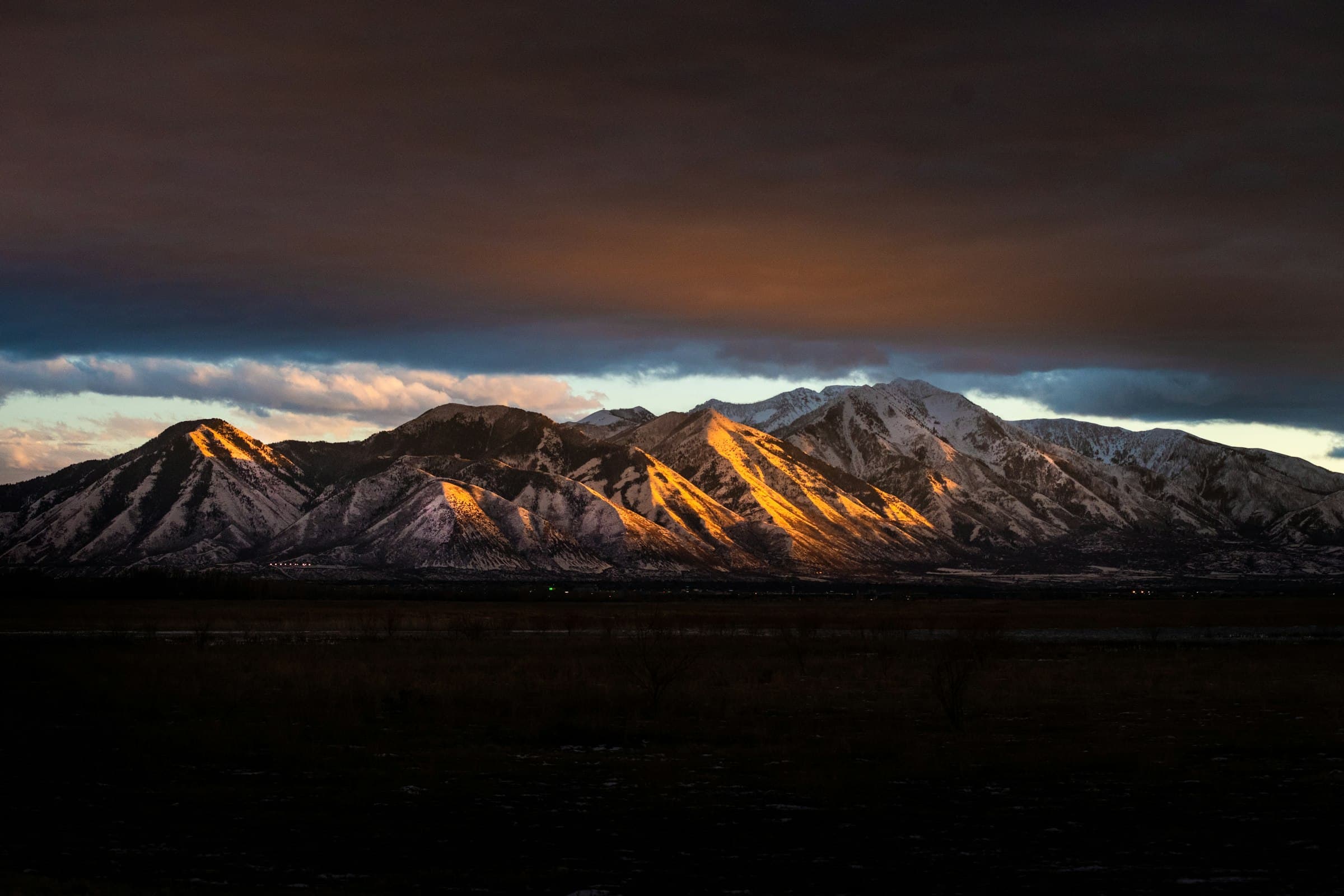 Last light raking across the snow-covered Wasatch Range